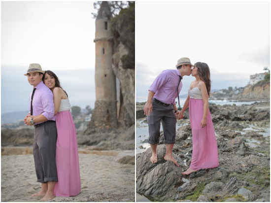 Romantic couple kissing at the beach near a stone tower