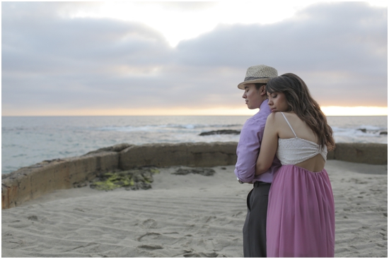 Couple embracing at the beach at sunset, romantic and tender scene