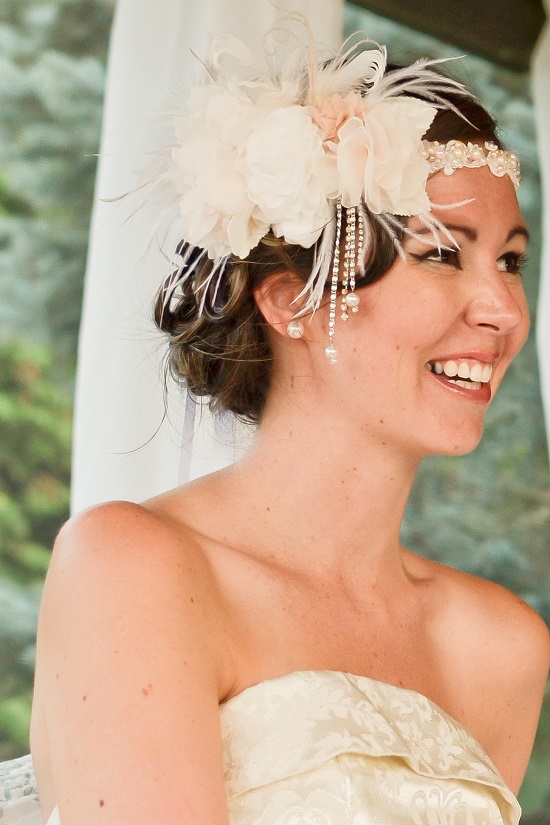 Happy bride wearing a beautiful flower and feather wedding headpiece