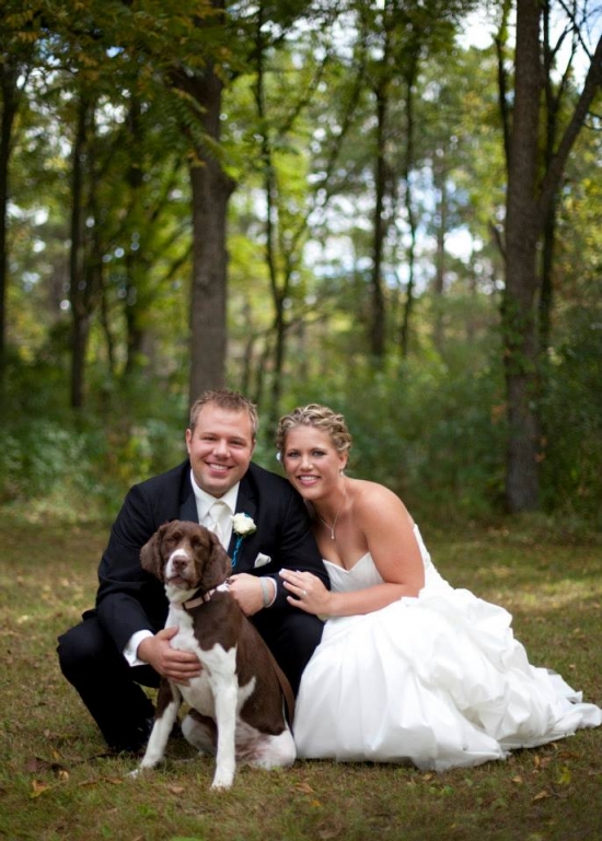 Happy couple with their dog at wedding in woods