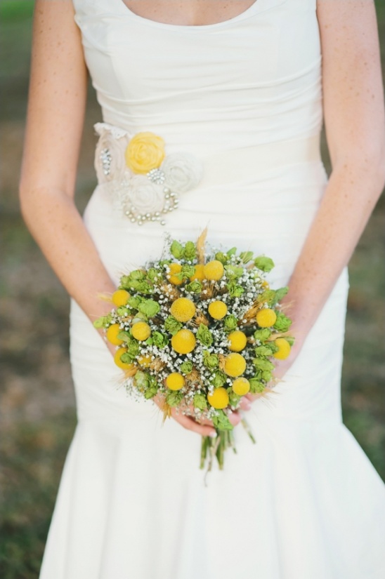 Bride holding a vibrant yellow and green flower bouquet