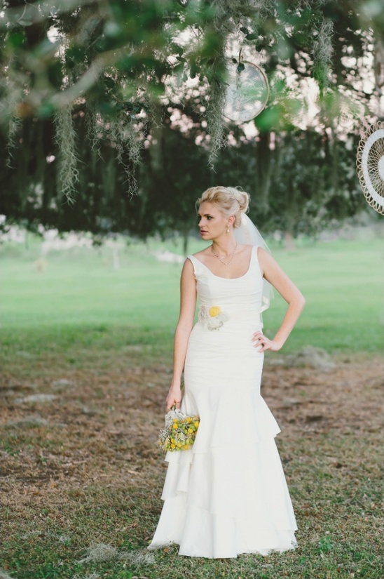 Bride in a white wedding dress with a bouquet in a dreamy setting