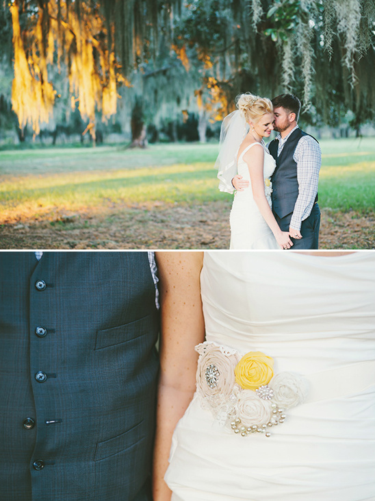 Couple embraces under a tree on their wedding day with yellow accents