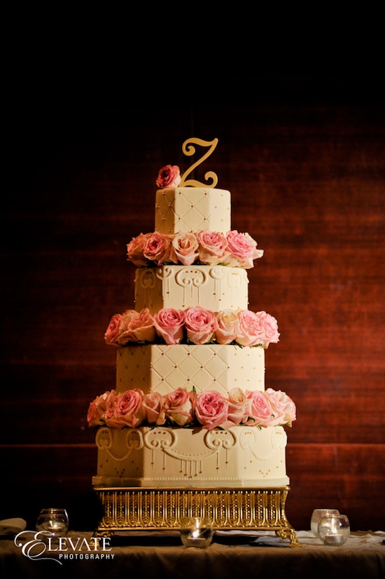 Beautiful wedding cake with pink roses and gold accents