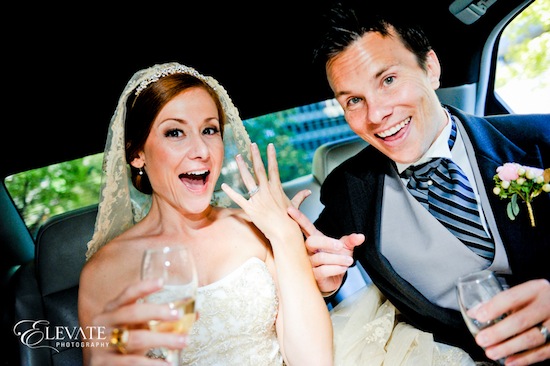 Happy bride and groom celebrating their wedding in a car