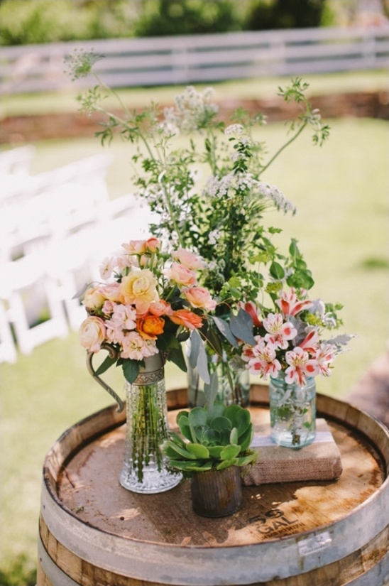 wedding ceremony florals on a wine barrel