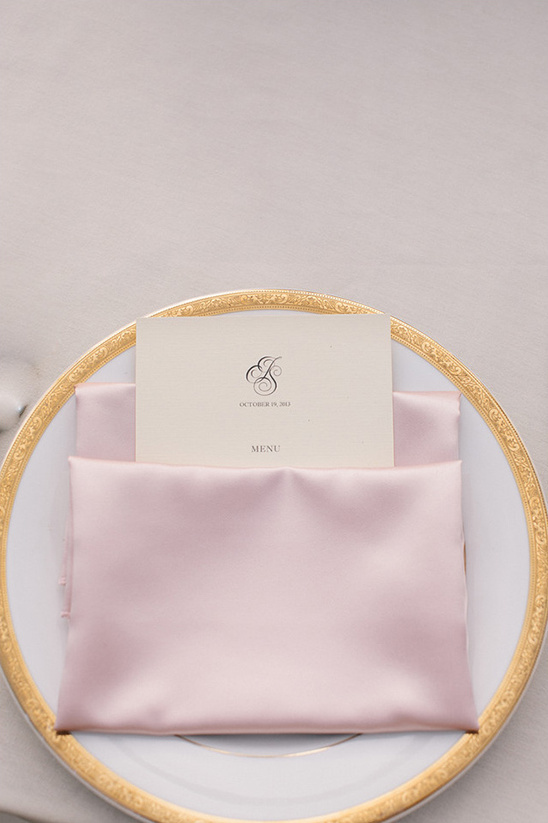 gold lined china and pink napkins