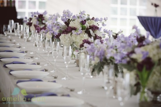 Purple and white floral centerpieces on a table