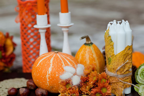Autumnal centerpiece: pumpkins, candles, and fall flowers