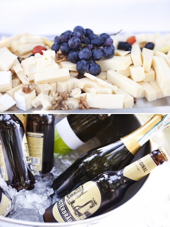 Cheese and grapes with beer and champagne on ice