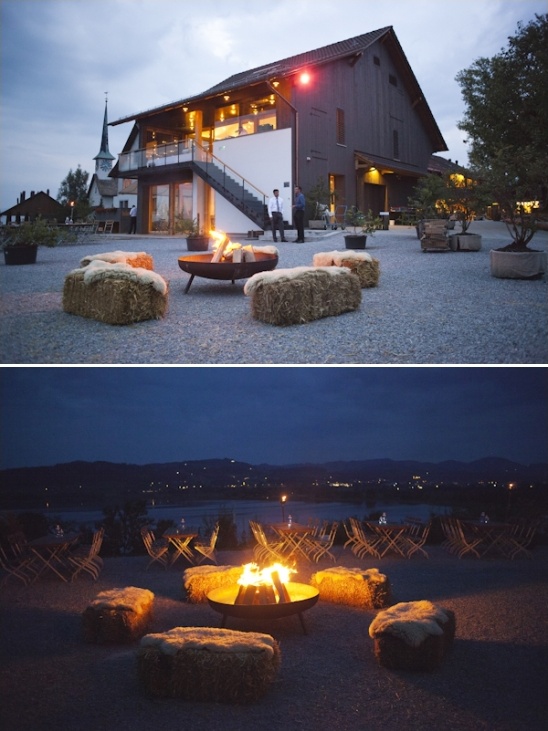 Rustic barn venue with bonfire and hay bale seating