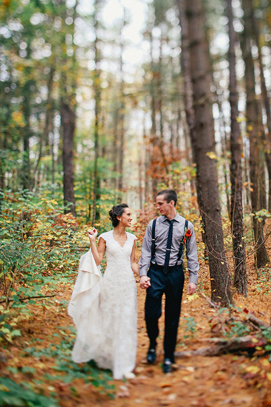 Happy couple strolls through autumn woods