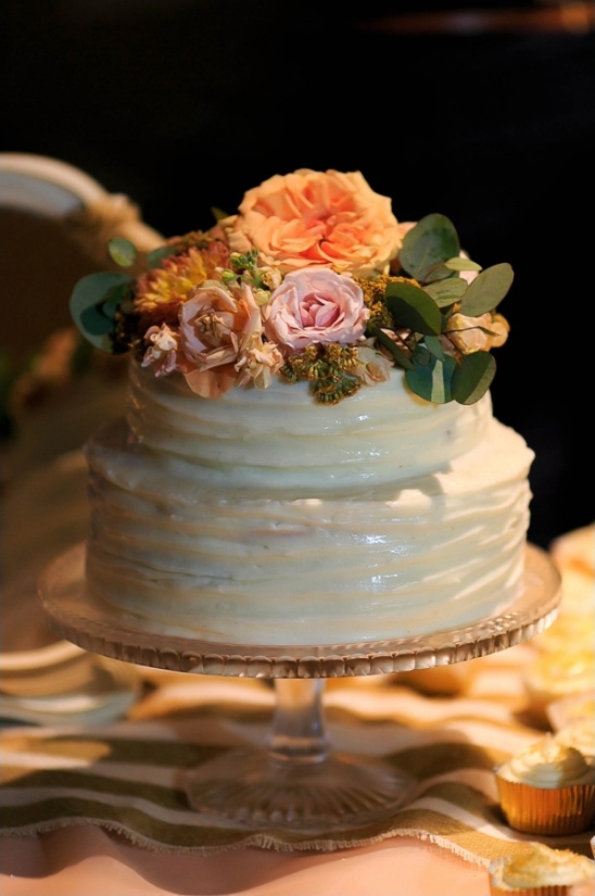 white wedding cake with peach floral toppers
