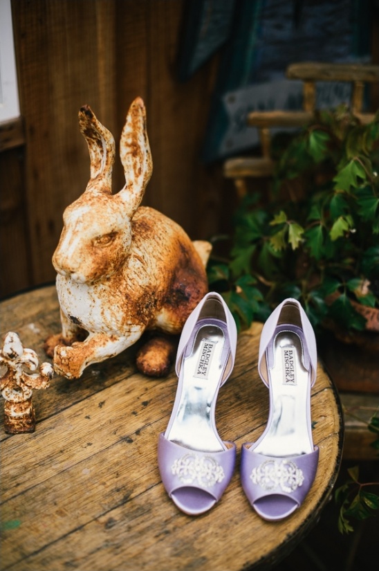 Lavender wedding shoes and rustic rabbit decor on wood