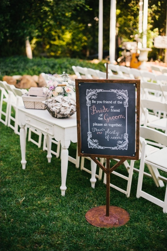 Wedding ceremony sign kindly asking guests to sit together
