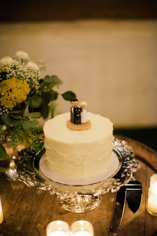 simple white wedding cake with cute custom topper