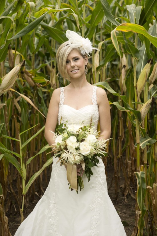 Bride in cornfield with white flowers