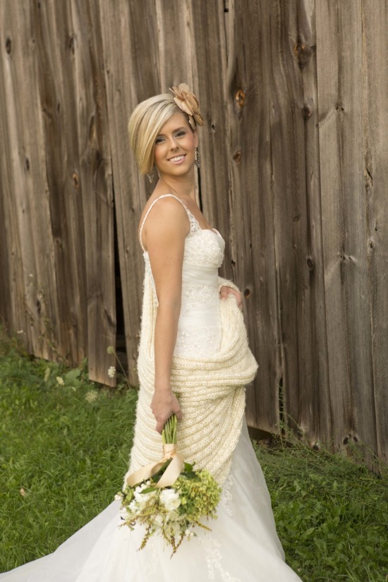 Bride in lace wedding dress with knit shawl