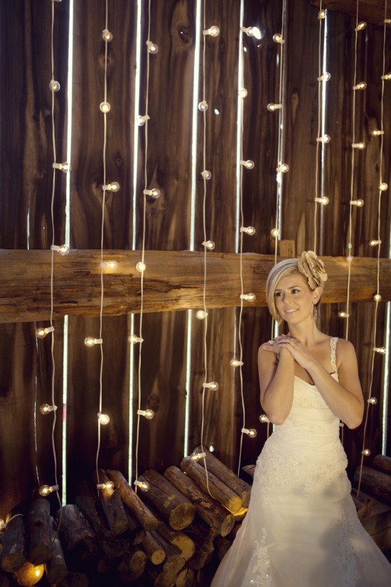Bride in barn with string lights