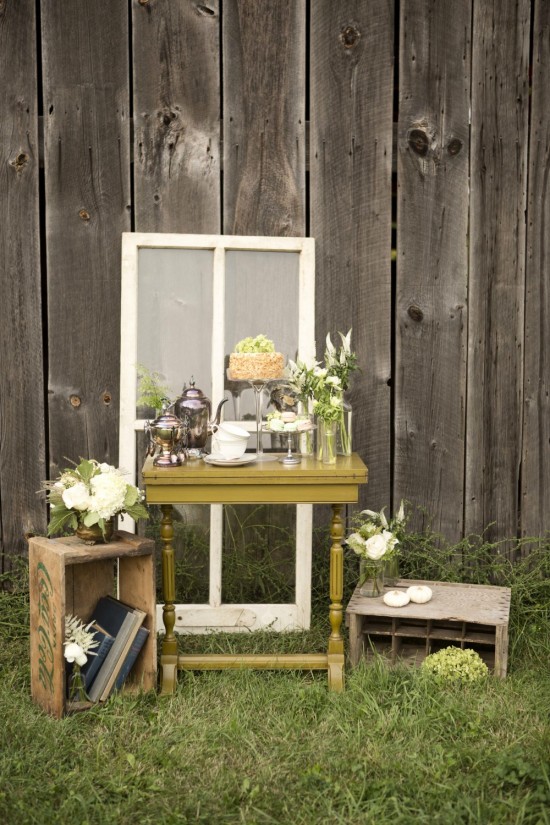Rustic tea party setup on wooden fence
