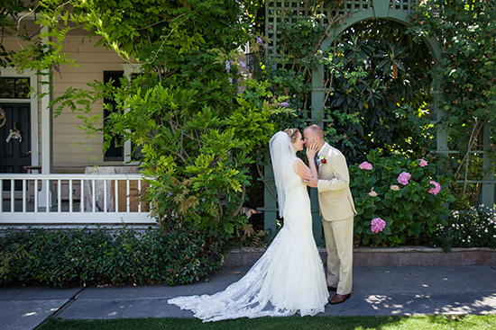 Bride and groom kiss on their outdoor wedding day