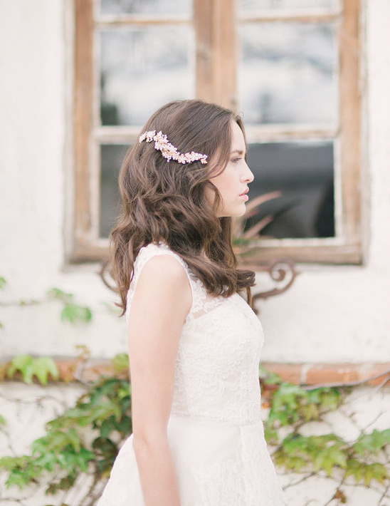 Bride in white lace dress with floral hairpiece