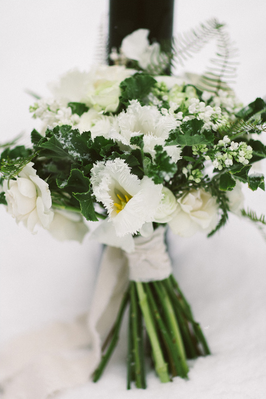 Elegant white wedding bouquet in snow