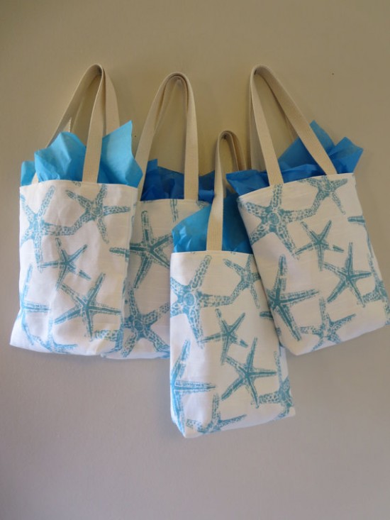 Four beachy tote bags with blue starfish print design