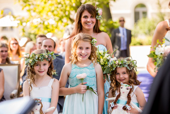 Happy bridesmaid and three flower girls with floral crowns