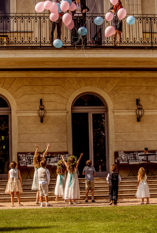 Children watching balloons released from a balcony, special moment