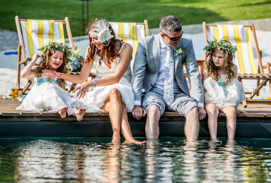Newlyweds and flower girls enjoy a pool on their wedding day