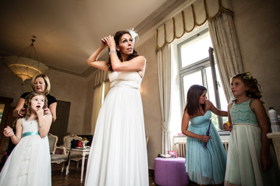 Bride adjusts her hair getting ready for the wedding