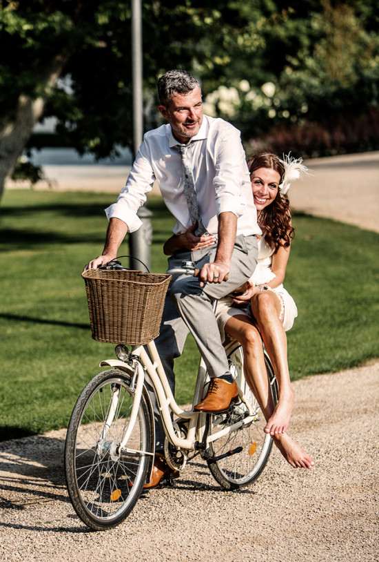 Happy couple riding a bike, enjoying a lovely sunny day together