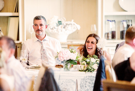 Happy bride laughing at wedding reception, joyful moment