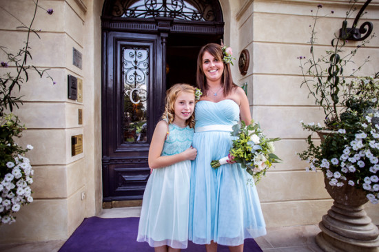 Bridesmaid and flower girl in blue dresses smiling