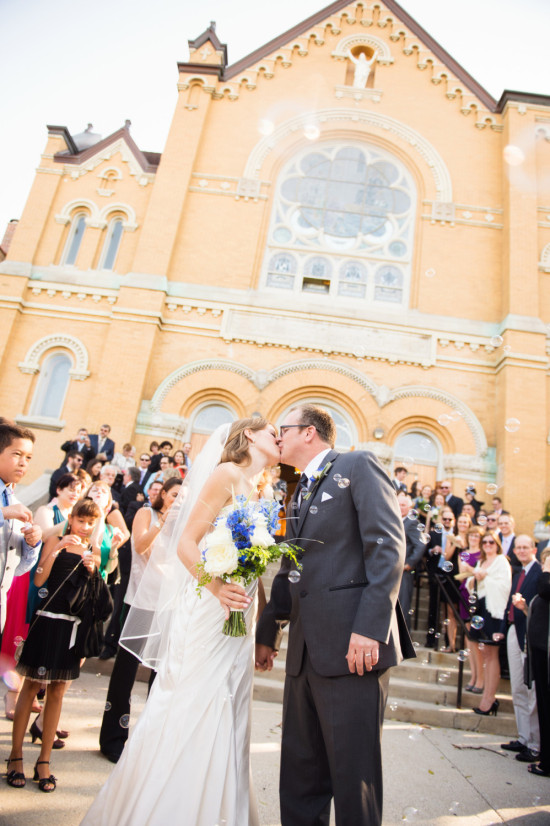 Bride and groom share a kiss after church wedding