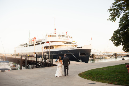 Bride and groom walk near a ship at Columbia Yacht Club