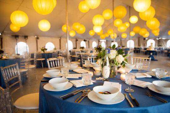 Elegant tent wedding reception with yellow paper lanterns