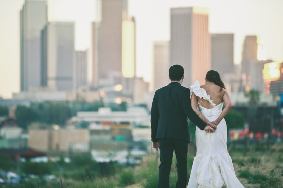 Couple holding hands with city skyline view behind