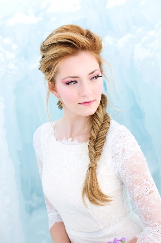 Blonde woman in white lace dress with fishtail braid