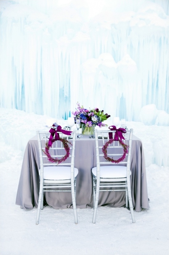 Romantic winter wedding table setting with ice backdrop