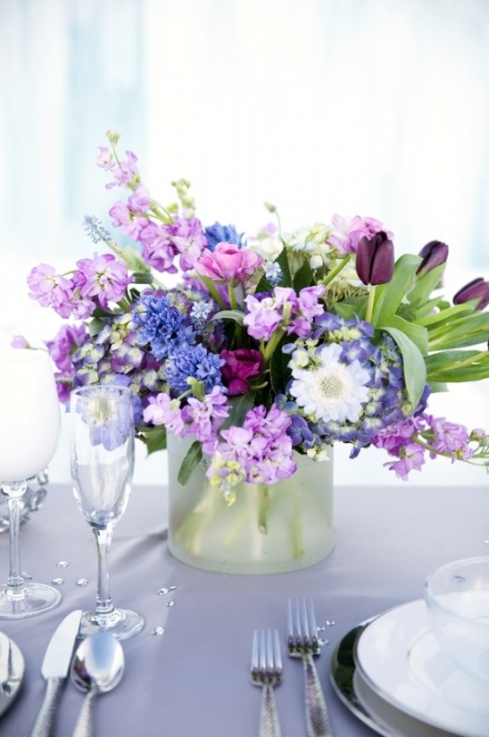 Purple and blue wedding centerpiece flowers in vase