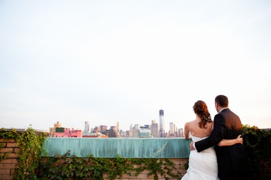 Wedding couple enjoys romantic city skyline view from rooftop