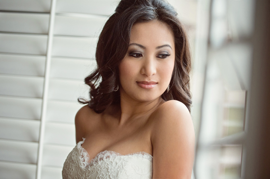 Beautiful bride in lace wedding dress looks serene