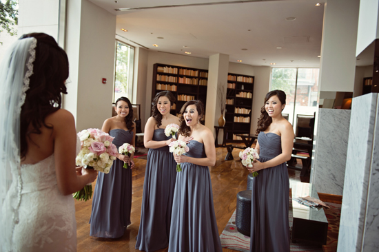 Bride and bridesmaids share an excited moment during wedding