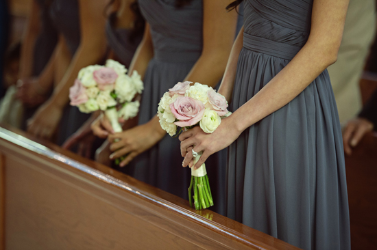 Bridesmaids in grey dresses holding floral bouquets