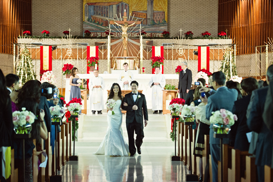 Bride and groom walking down aisle at church wedding