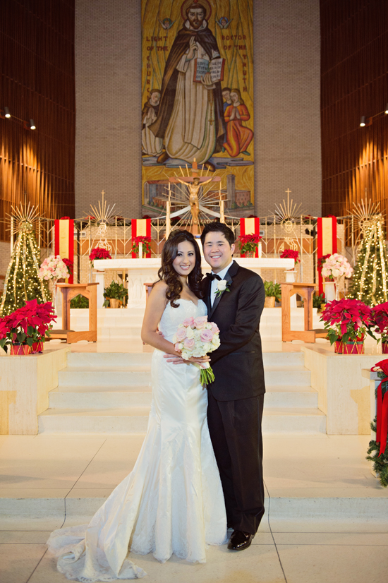 Bride and groom posing on wedding day at church altar