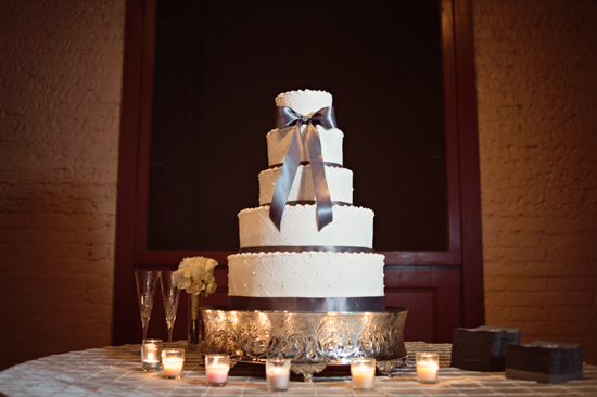 Elegant four tier wedding cake with gray ribbon bow