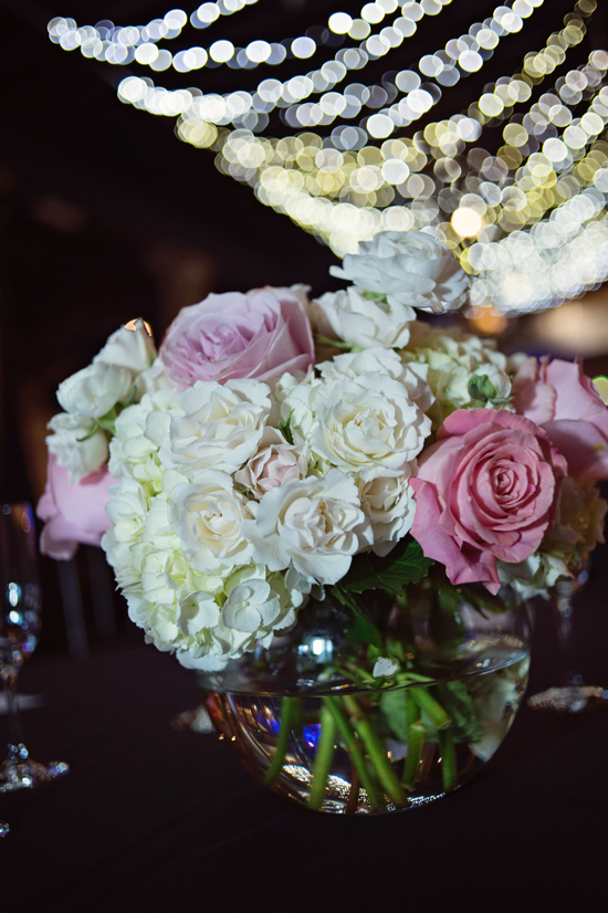Elegant floral arrangement with roses and lights above